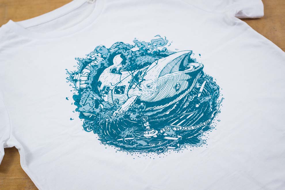 Blue whale surrounded by water on tshirt
